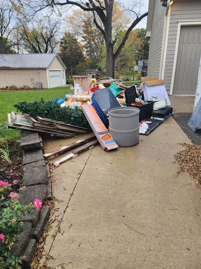 Dumpster being loaded with debris for 12 Yard Dumpster Rental in Boiling Springs